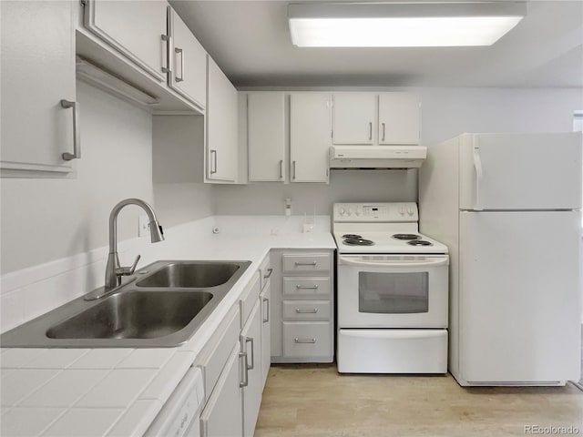 kitchen featuring tile countertops, sink, white cabinets, and white appliances