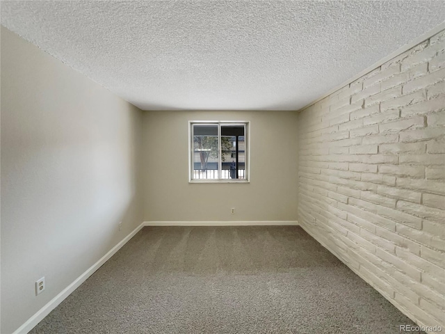 carpeted empty room with a textured ceiling