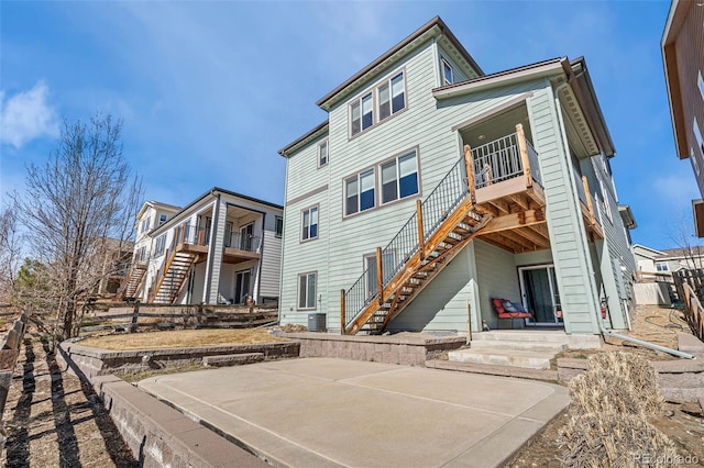 back of property featuring a patio and stairs