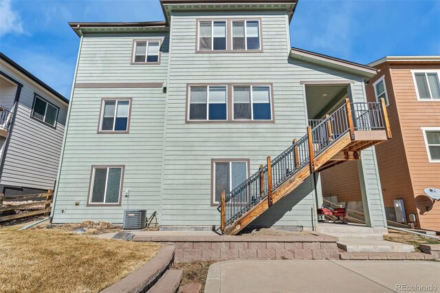 rear view of property with central air condition unit, a patio area, and stairs