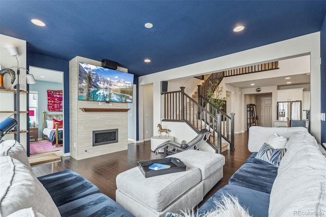 living room with stairway, a fireplace, wood finished floors, and recessed lighting