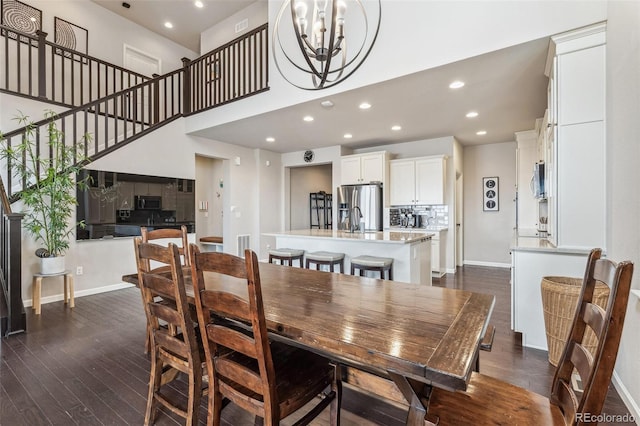 dining area with baseboards, a chandelier, dark wood-style flooring, and recessed lighting