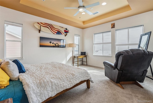 bedroom with visible vents, a raised ceiling, baseboards, carpet, and recessed lighting