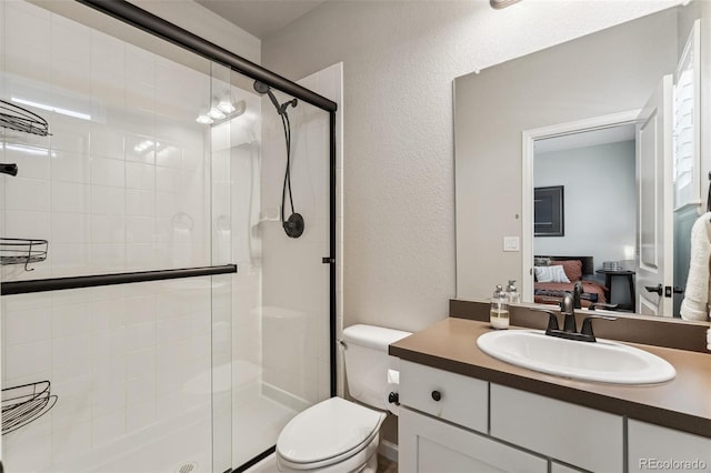 ensuite bathroom with a textured wall, toilet, ensuite bath, vanity, and a shower stall