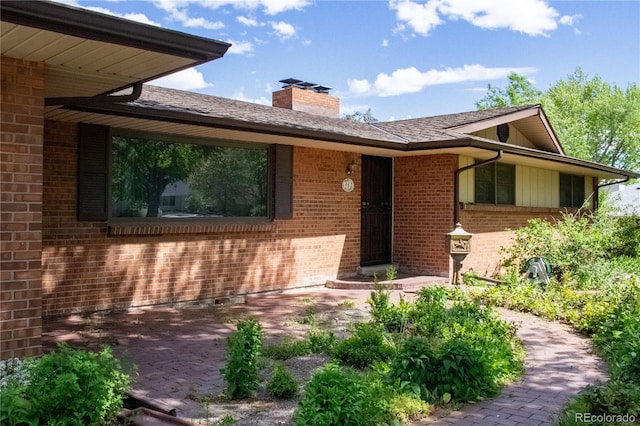 962 S Beech St, Lakewood, CO 80228 - doorway to property with brick siding and a chimney