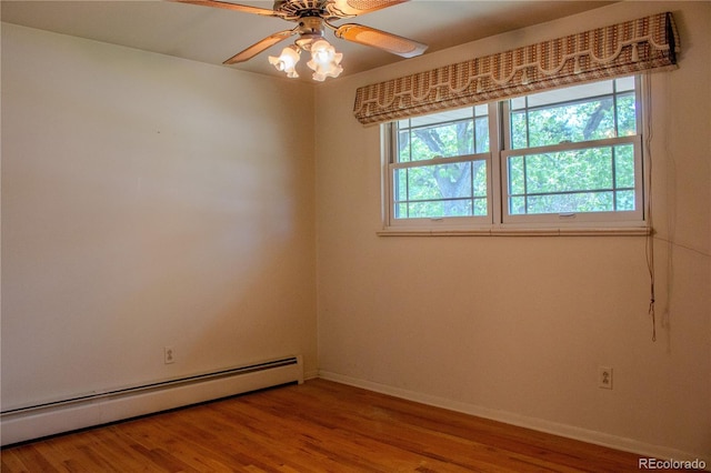 962 S Beech St, Lakewood, CO 80228 - unfurnished room with a baseboard heating unit, baseboards, wood finished floors, and a ceiling fan