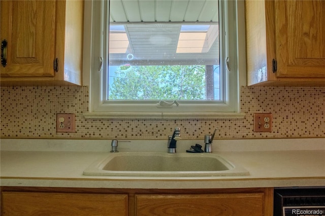 962 S Beech St, Lakewood, CO 80228 - kitchen featuring a sink, light countertops, dishwashing machine, and backsplash