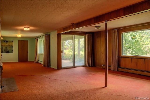 962 S Beech St, Lakewood, CO 80228 - unfurnished room featuring carpet flooring, a baseboard heating unit, and wood walls