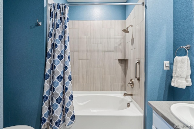 full bath featuring vanity, a textured wall, and shower / bath combo with shower curtain