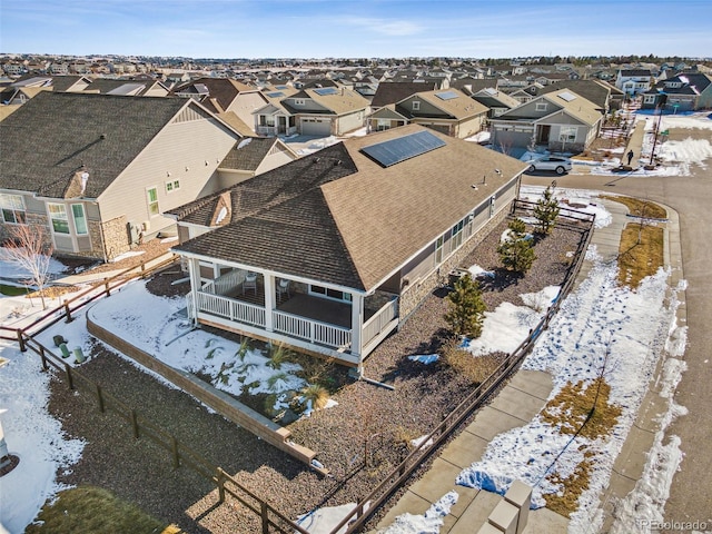 snowy aerial view with a residential view