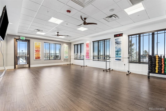 interior space featuring a ceiling fan, wood finished floors, a healthy amount of sunlight, and visible vents