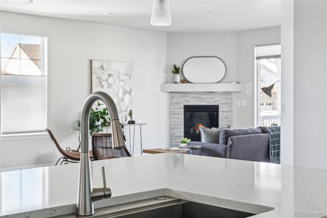 interior space featuring stone countertops, a tile fireplace, and a sink