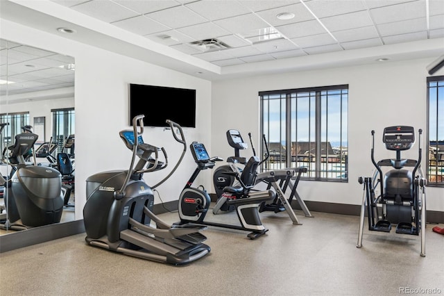 exercise room featuring baseboards, visible vents, and a drop ceiling