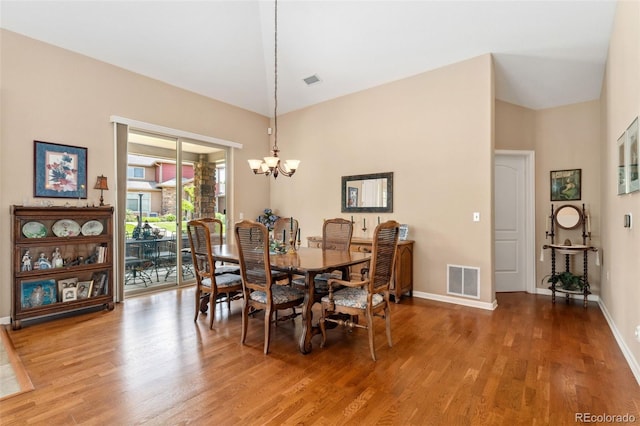 8595 Gold Peak Dr Unit A, Highlands Ranch, CO 80130 - dining space featuring a chandelier, wood finished floors, baseboards, and a towering ceiling