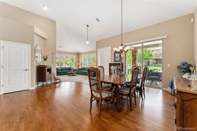 8595 Gold Peak Dr Unit A, Highlands Ranch, CO 80130 - dining area with a chandelier, wood finished floors, high vaulted ceiling, and baseboards