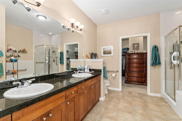 8595 Gold Peak Dr Unit A, Highlands Ranch, CO 80130 - full bath with a spacious closet, a stall shower, double vanity, and toilet