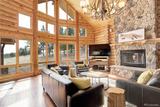 14753 Kit Carson Peak Trl, Pine, CO 80470 - living room featuring high vaulted ceiling, a chandelier, hardwood / wood-style floors, a fireplace, and wooden ceiling