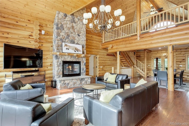 14753 Kit Carson Peak Trl, Pine, CO 80470 - living room featuring log walls, high vaulted ceiling, hardwood / wood-style floors, wood ceiling, and stairs