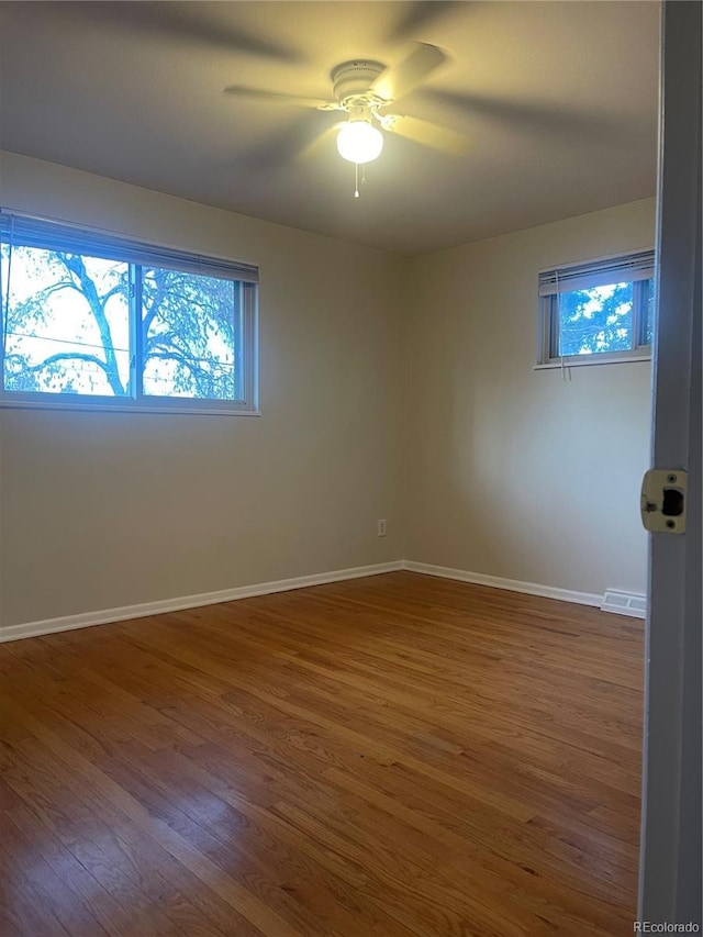 spare room featuring hardwood / wood-style flooring and ceiling fan