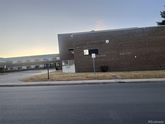 view of outdoor building at dusk