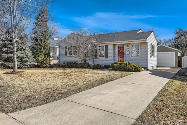 single story home featuring a garage, an outbuilding, roof with shingles, and driveway