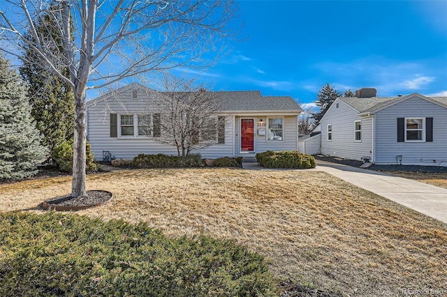 single story home with a shingled roof and a front yard