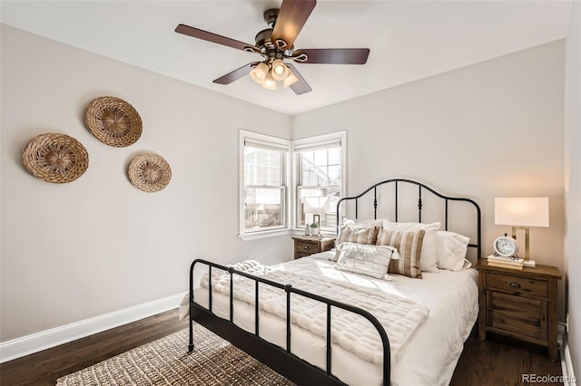 bedroom with a ceiling fan, dark wood-style floors, and baseboards