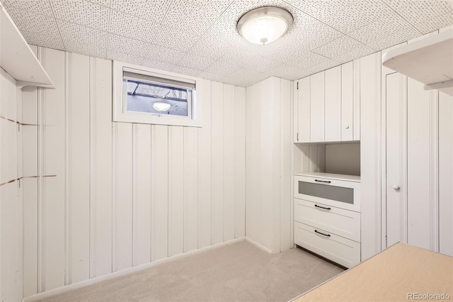 walk in closet featuring light carpet