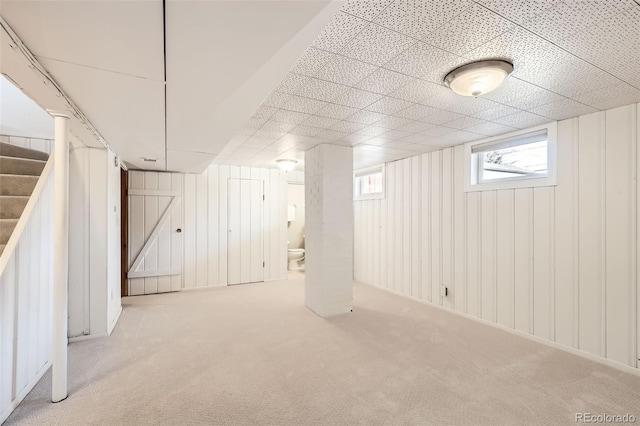 basement featuring carpet and stairs