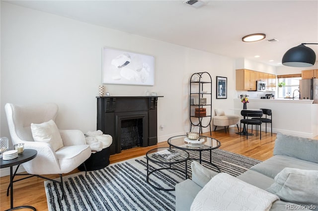 living room with light hardwood / wood-style floors