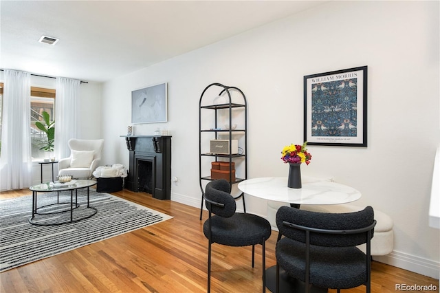 dining space with hardwood / wood-style flooring