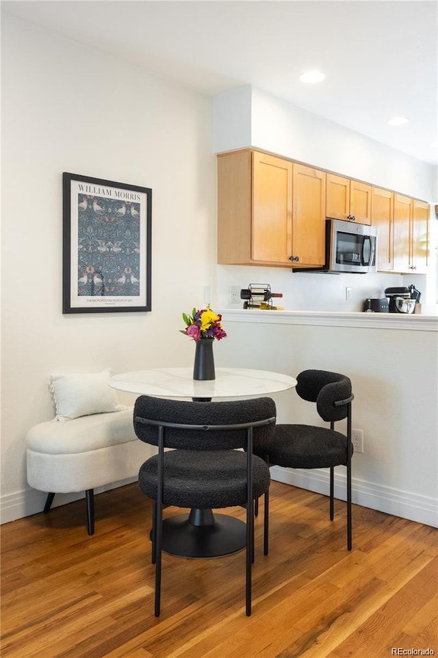 dining space with breakfast area and light hardwood / wood-style floors