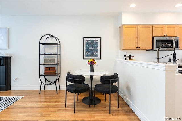 dining space with light wood-type flooring