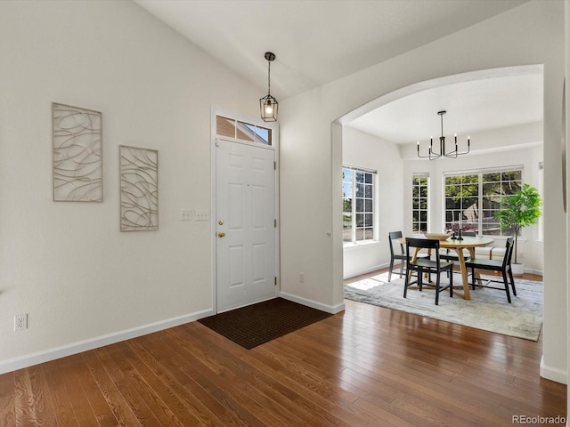 12335 E 2nd Dr, Aurora, CO 80011 - foyer with a chandelier, dark wood-style floors, baseboards, and vaulted ceiling