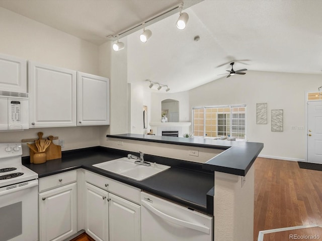 12335 E 2nd Dr, Aurora, CO 80011 - kitchen featuring white appliances, a sink, dark countertops, ceiling fan, and lofted ceiling