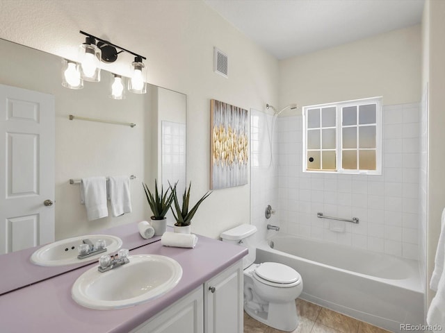12335 E 2nd Dr, Aurora, CO 80011 - bathroom with vanity, shower / bathtub combination, toilet, and tile patterned flooring
