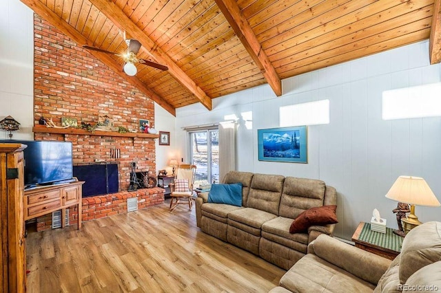 living room with ceiling fan, wooden ceiling, vaulted ceiling with beams, a fireplace, and light wood-type flooring