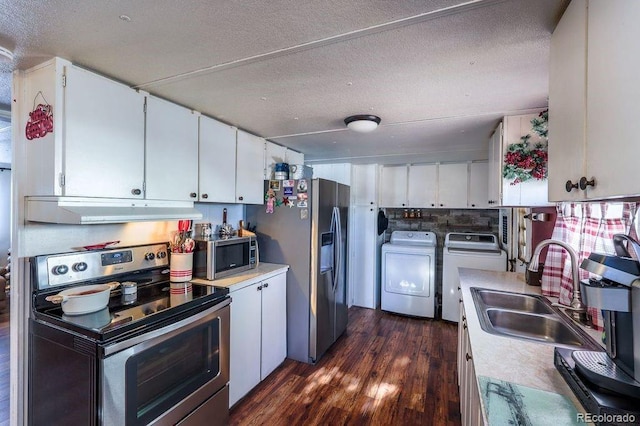 kitchen with independent washer and dryer, sink, white cabinets, and appliances with stainless steel finishes