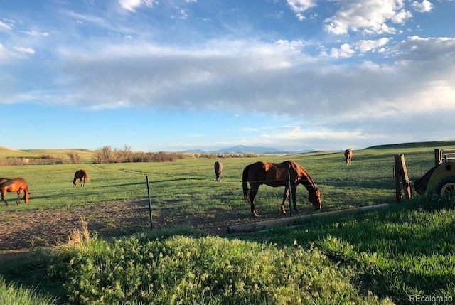 surrounding community with a lawn and a rural view