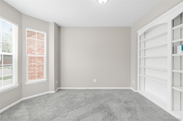 spare room with carpet and baseboards