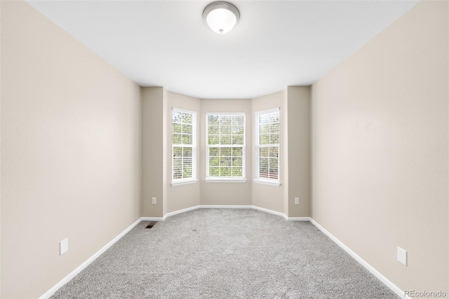 empty room with carpet flooring and baseboards