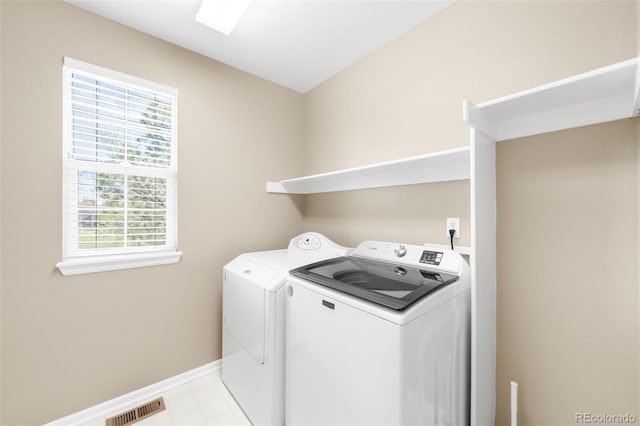 laundry room featuring washer and dryer and baseboards