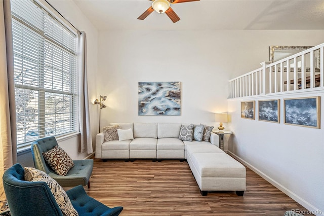 living room with wood-type flooring and ceiling fan