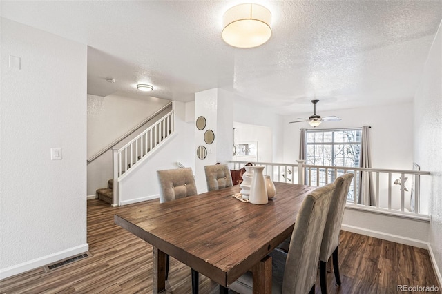 dining area with dark hardwood / wood-style floors and a textured ceiling