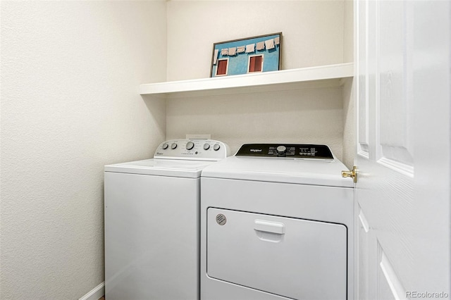 laundry area featuring washing machine and clothes dryer