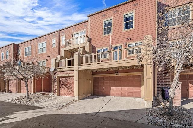 view of front of home with a garage and a balcony