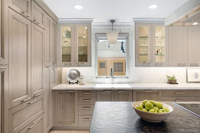 bar with a sink, wall chimney exhaust hood, pendant lighting, and backsplash