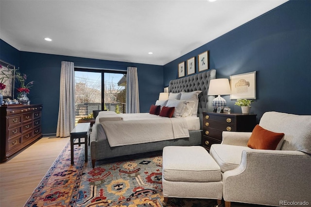 bedroom with access to outside, recessed lighting, and wood finished floors