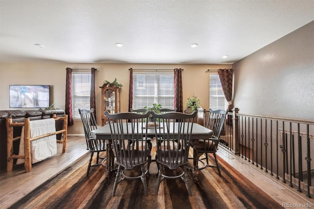 dining space with recessed lighting and wood finished floors