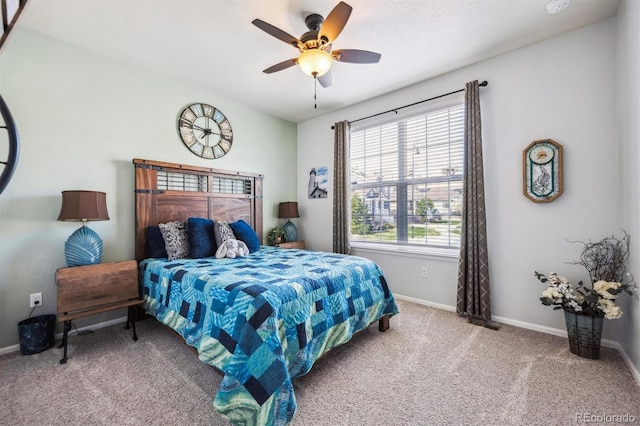 carpeted bedroom featuring baseboards and a ceiling fan